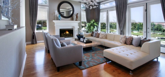 Modern living room with a cozy fireplace and stylish couches, creating a warm, inviting atmosphere