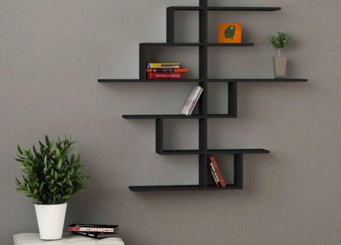 A black wall shelf adorned with various books and vibrant plants, creating an inviting display.