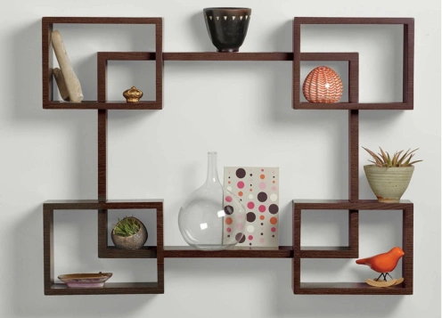 A wall shelf displaying a variety of decorative items and books amplify the room's appeal.