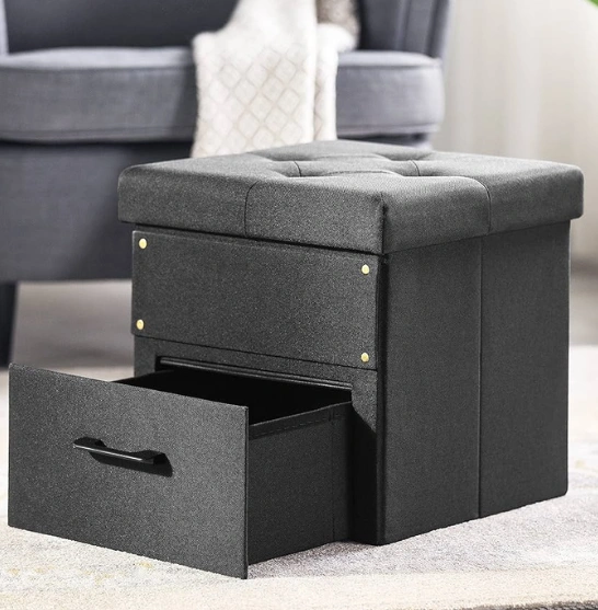 A gray ottoman featuring two drawers on top, providing both style and storage for any living space.