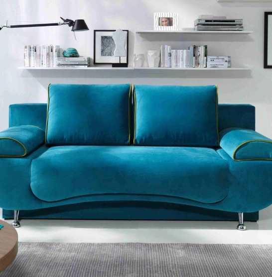 A modern blue couch in a stylish living room with a sleek coffee table creates a cozy atmosphere.