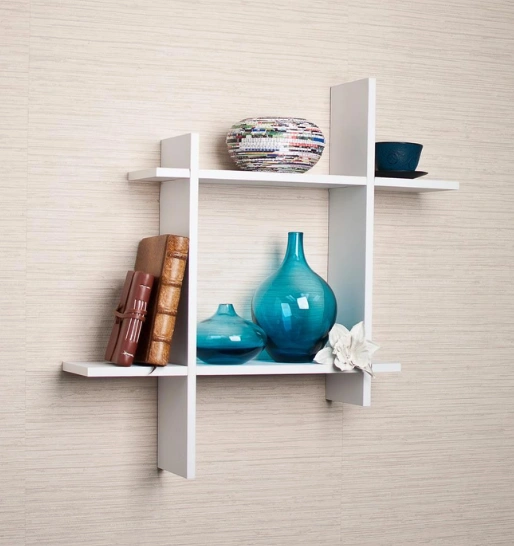 A white three-tier shelf displays elegant vases & books, amplifying the interior design of the space
